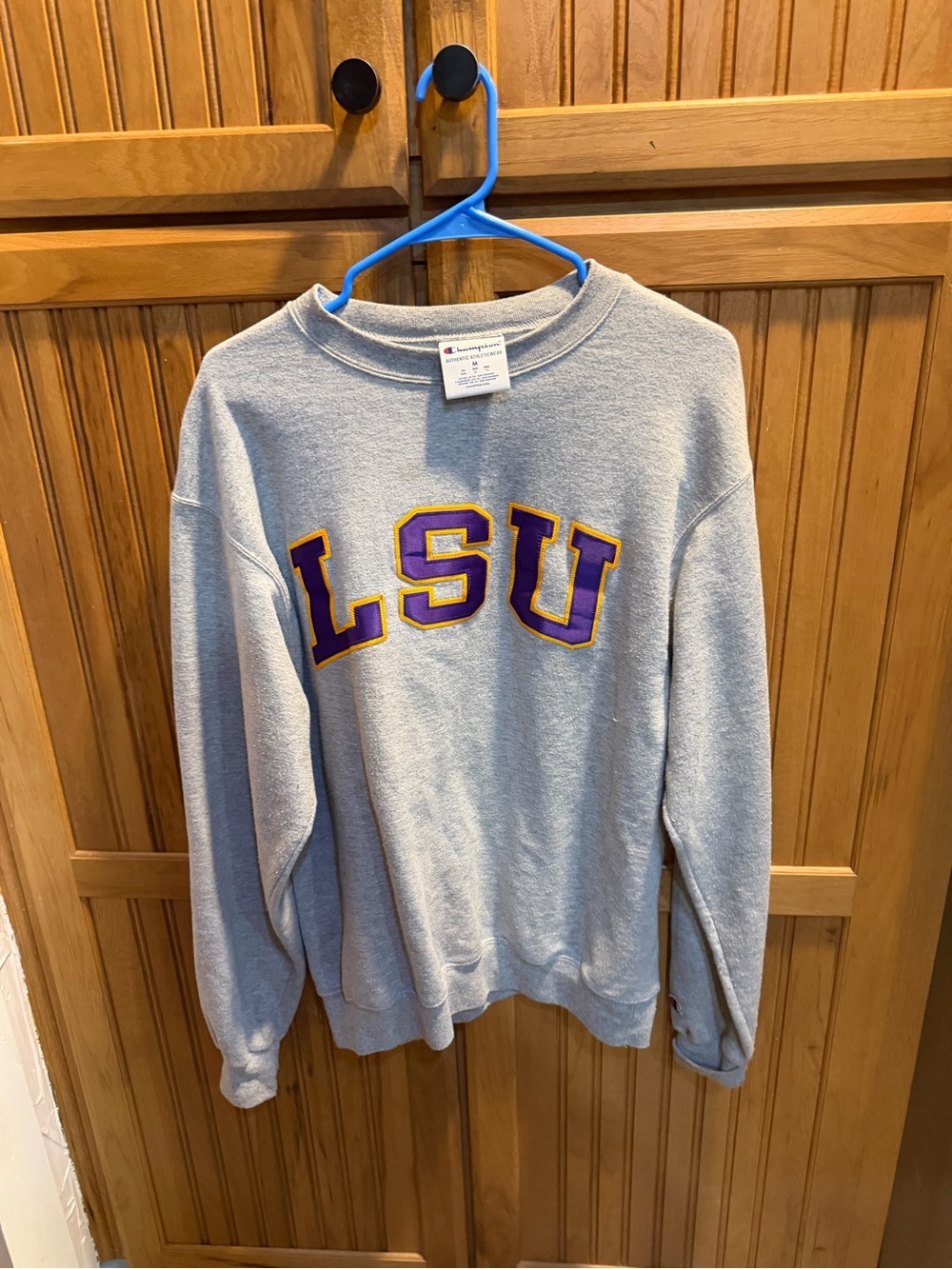 Champion Gray Sweatshirt Tag Close-Up with Blue & Red Logo